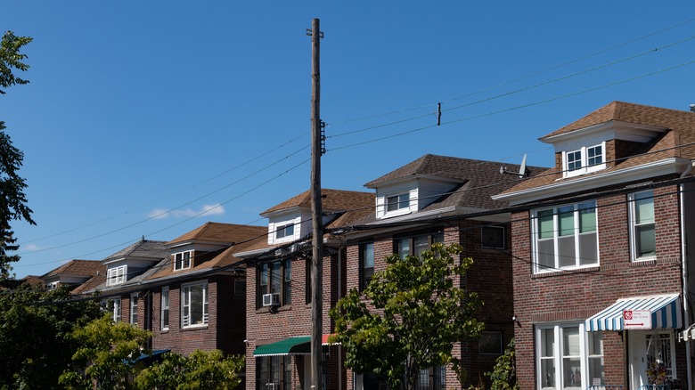 Brick houses in Woodside, New York with blue sky overhead