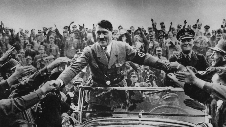 Adolf Hitler greets crowds from car 1933