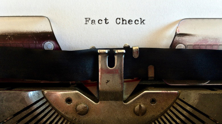 typewriter with fact check on paper