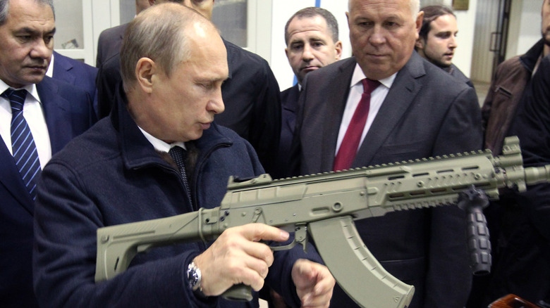 Putin holds a Kalashnikov