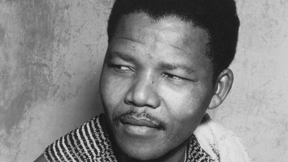 South African anti-apartheid revolutionary Nelson Mandela (1918 - 2013) wearing traditional beads and a bed spread during his time in hiding from the police, South Africa, 1961. 