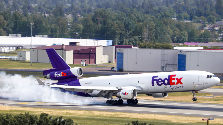 FedEx plane landing with smoke