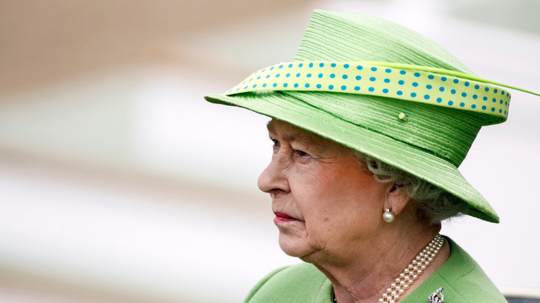 Queen Elizabeth II green hat looking in the distance