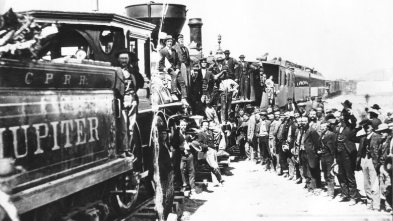 Crowd of men surrounding train