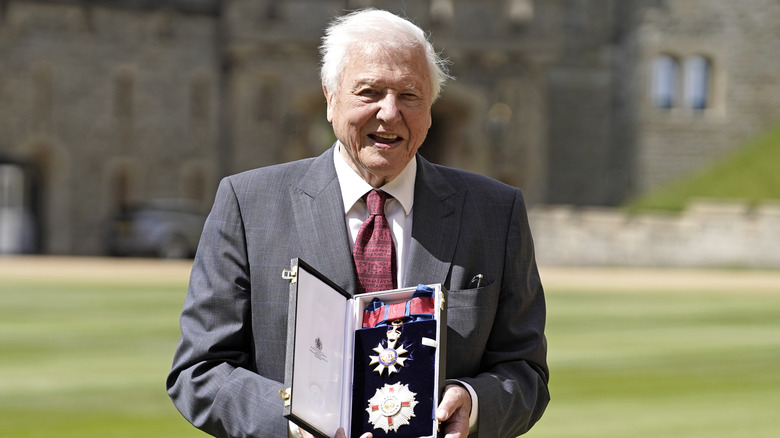 Attenborough displaying medal