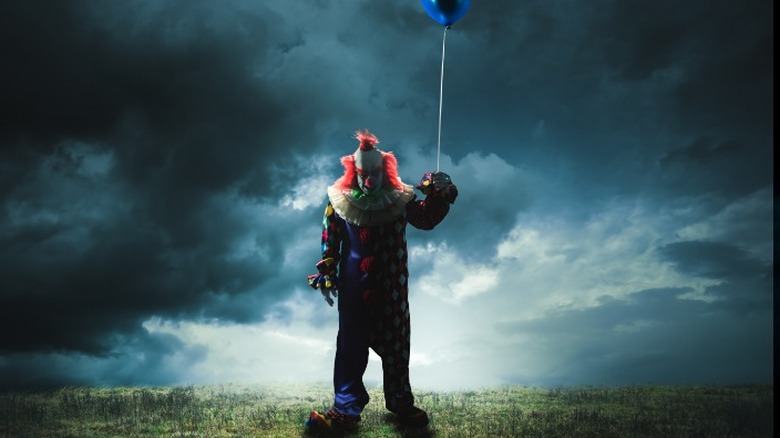clown holding balloon