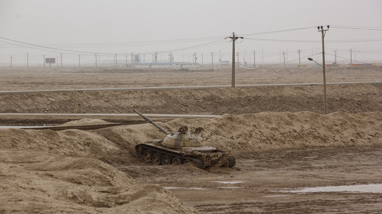 Border town between Iran and Iraq, with leftover Iranian tank in the foreground