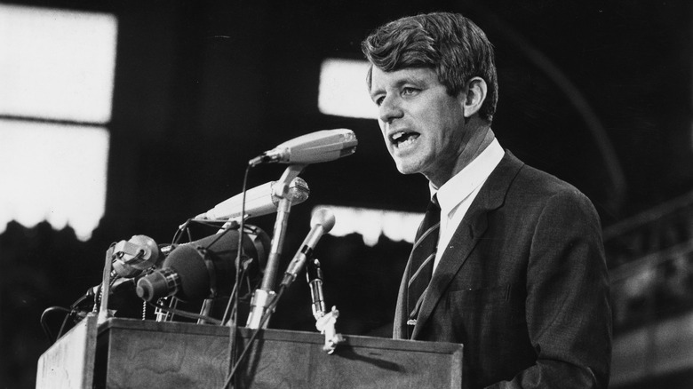 Robert Kennedy standing at a podium giving a speech 