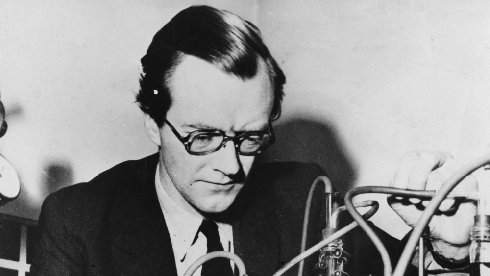black and white photo of Maurice Wilkins with beakers