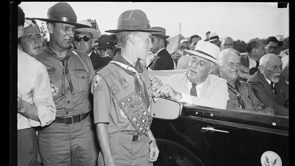 President Franklin Delano Roosevelt pins badge on Boy Scout