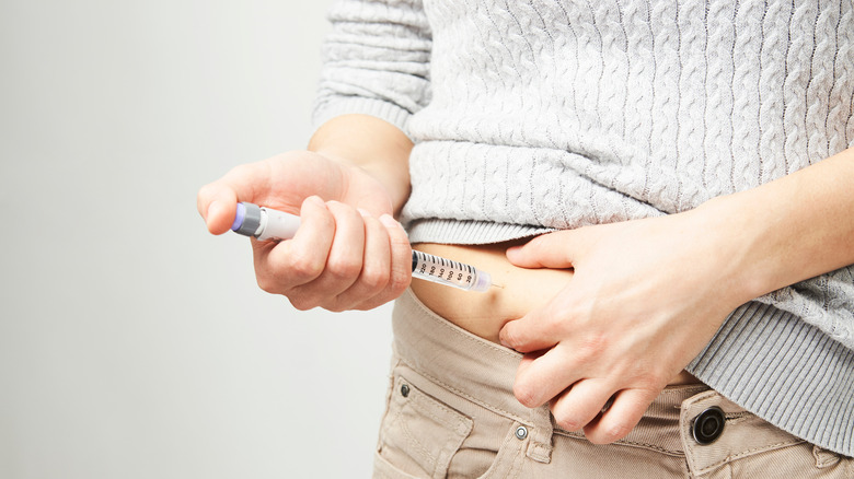 person using insulin injection pen