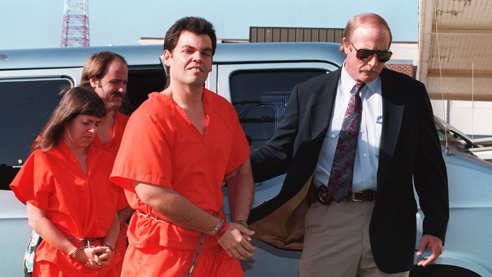 Branch Davidian members (L-R) Kathryn Schroeder, Brad Branch and Kevin Whitecliff in orange jumpsuits and handcuffs on 1 April 1993 being escorted by U.S. marshal into federal court