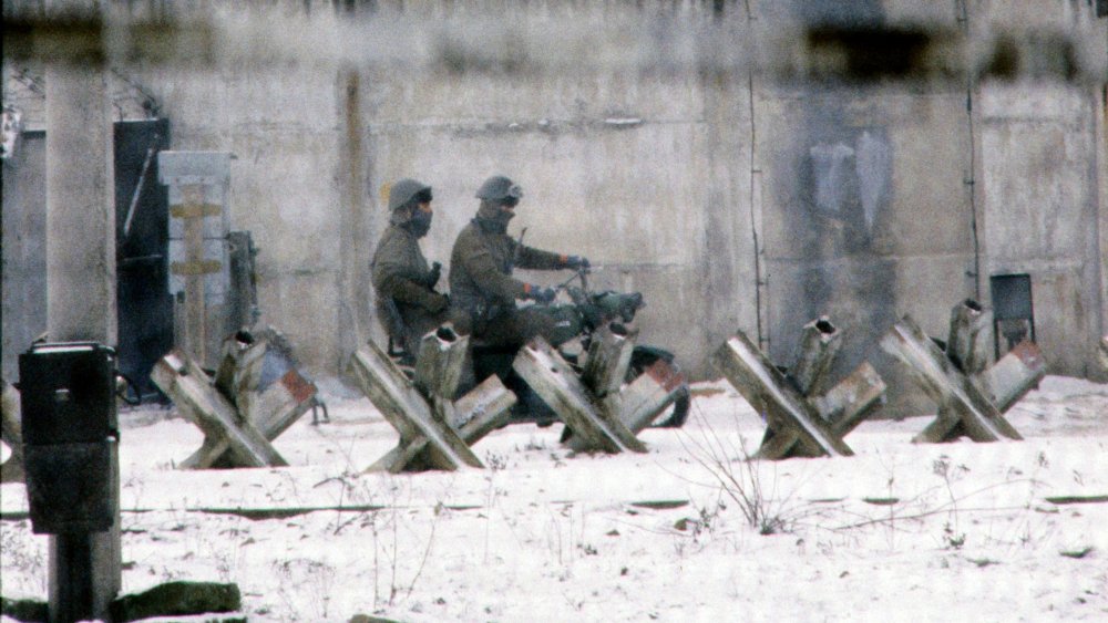 East German border guards patrol the wall