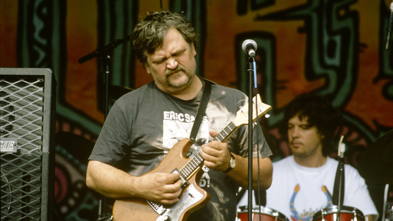 Bruce Hampton playing a small guitar on stage