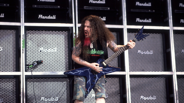 'Dimebag' Darrell Abbott playing guitar in front of amps
