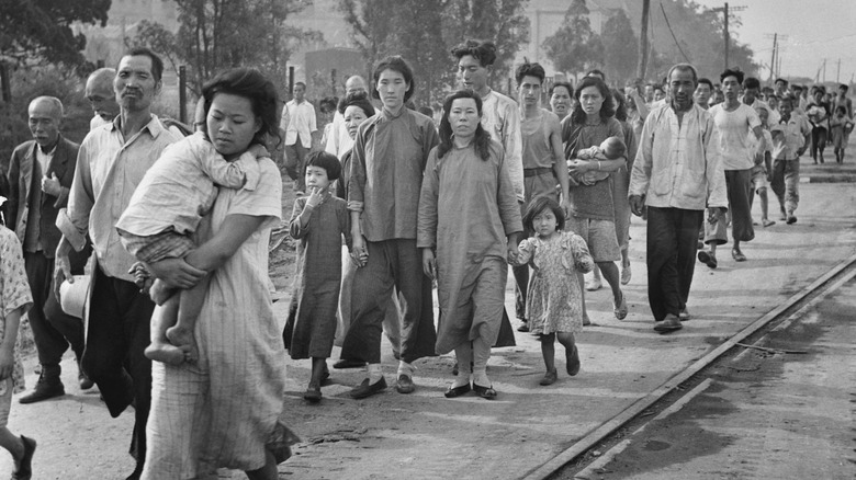 Korean refugees walking on bridge