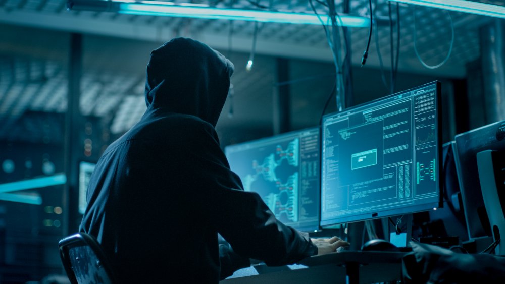 Hooded figure with computers
