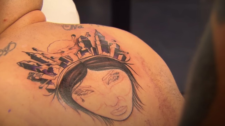 Ink Master girl with a city on her head tattoo