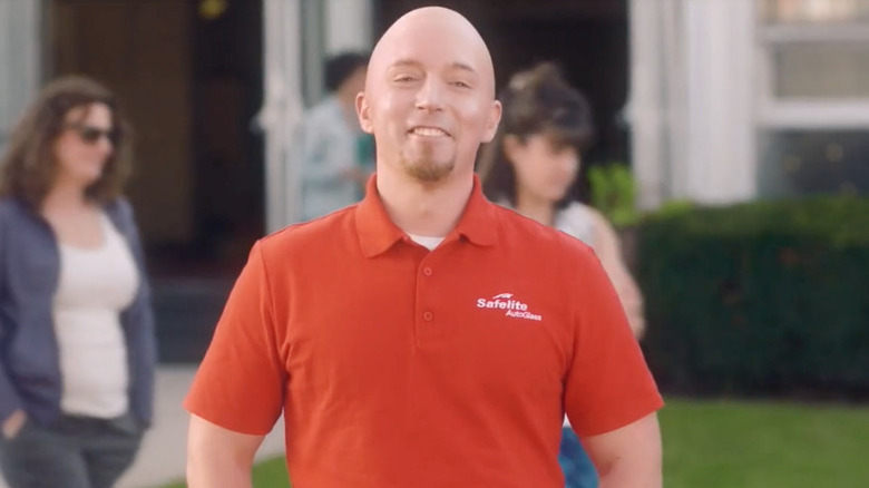 Bald Beck Bennett smiling red shirt outside