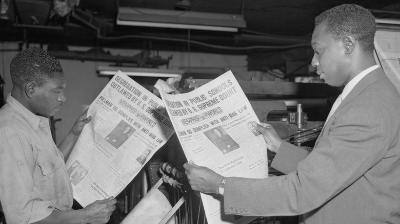 Black Americans reading newspaper