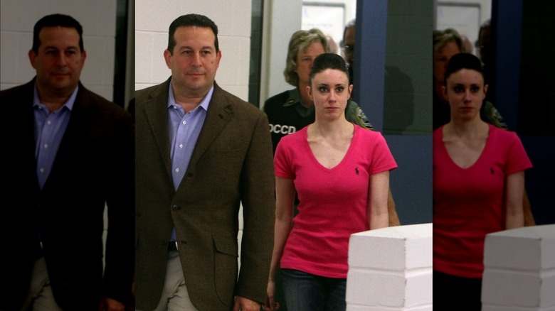 Casey Anthony in pink shirt walking with lawyer