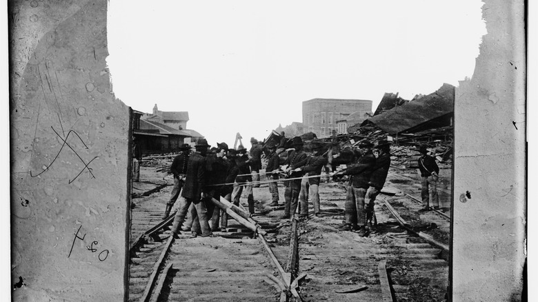 Union soldiers rip up railroads on the march to the sea