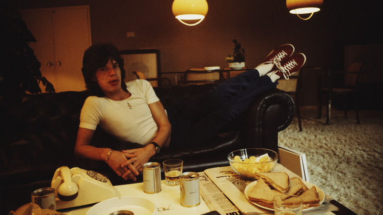 Mick Jagger laying on couch