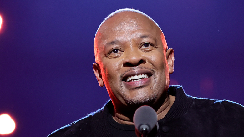 Dr. Dre smiling on stage mic