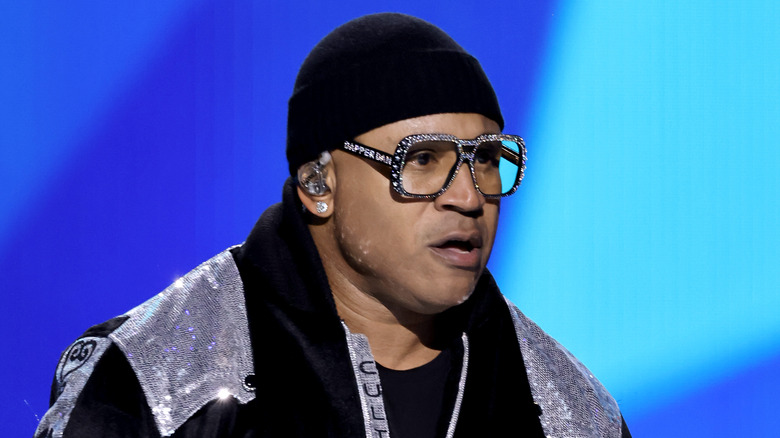LL Cool J performing sparkly glasses and jacket black hat