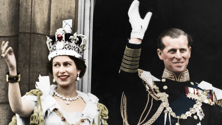 Queen Elizabeth and Prince Philip wave