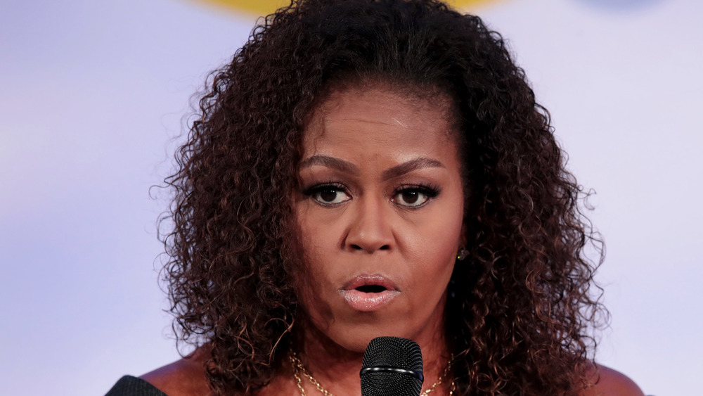 Michelle Obama speaking at microphone 