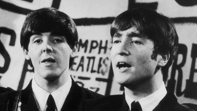 Paul McCartney performing with John Lennon