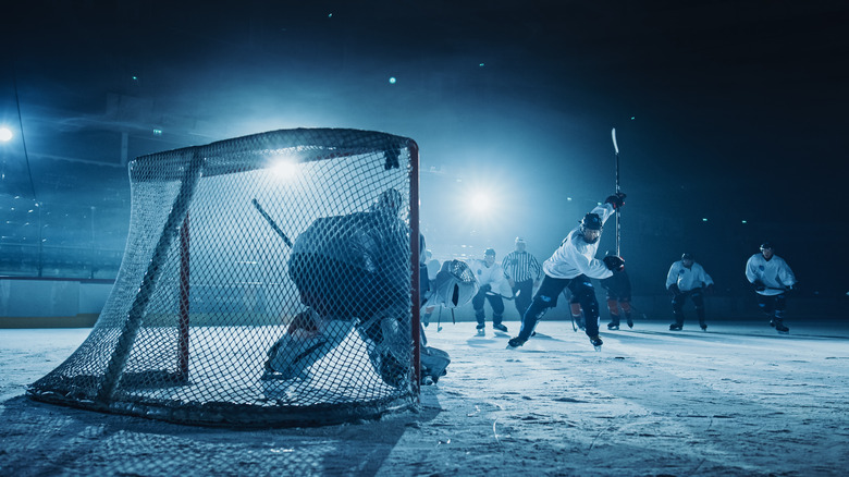 Hockey players on darkened rink