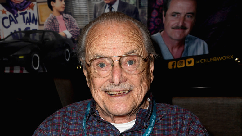 William Daniels surrounded by old photos at event