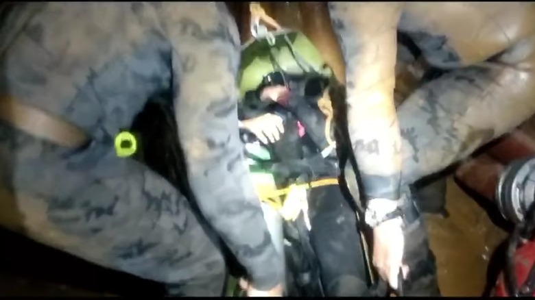 rescuers bringing out boy