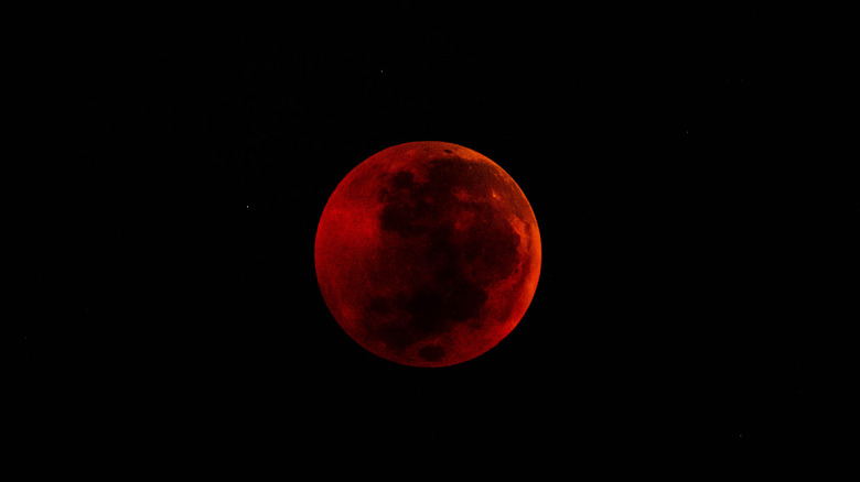 Blood moon in black sky