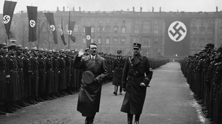 Hitler walking by Nazi troops