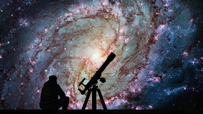Telescope silhouette over Pinwheel Galaxy 