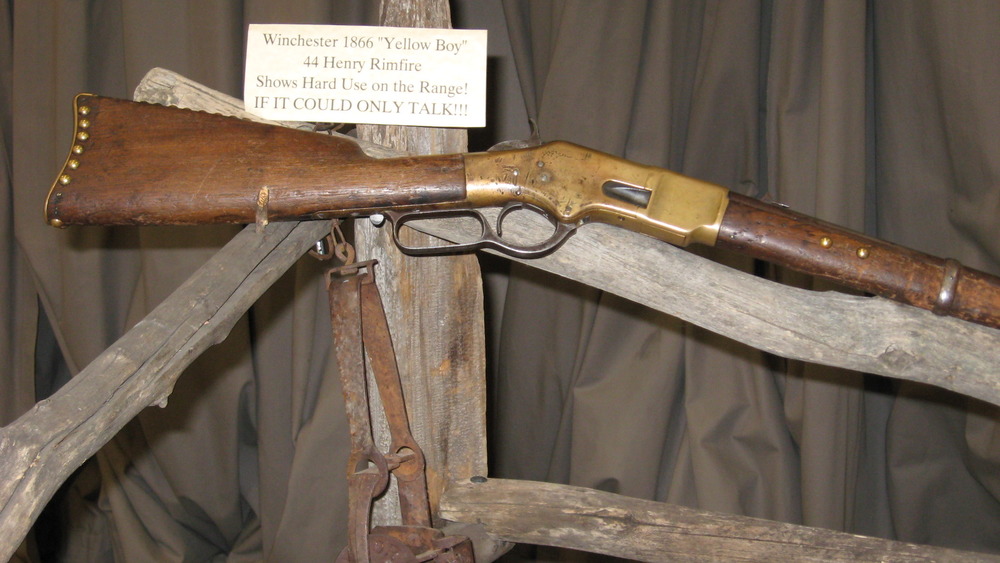 An 1866 Winchester "yellow boy" sits on a stand