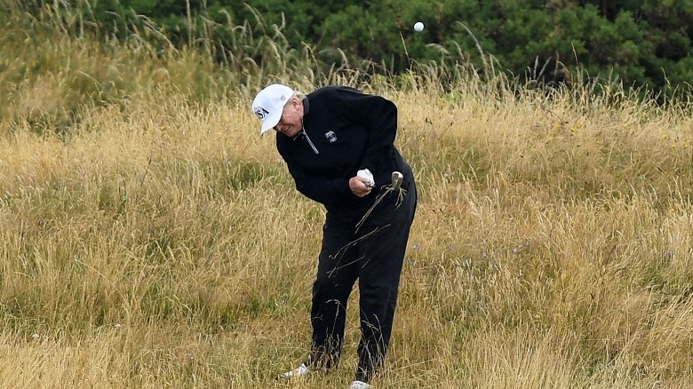 Trump hitting golf ball