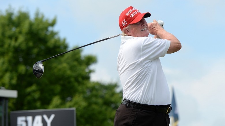 Trump swinging golf club
