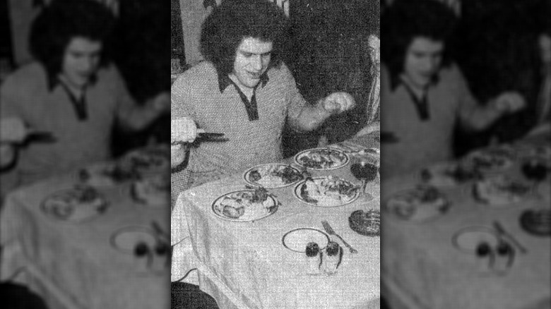 Andre newspaper photo at table eating