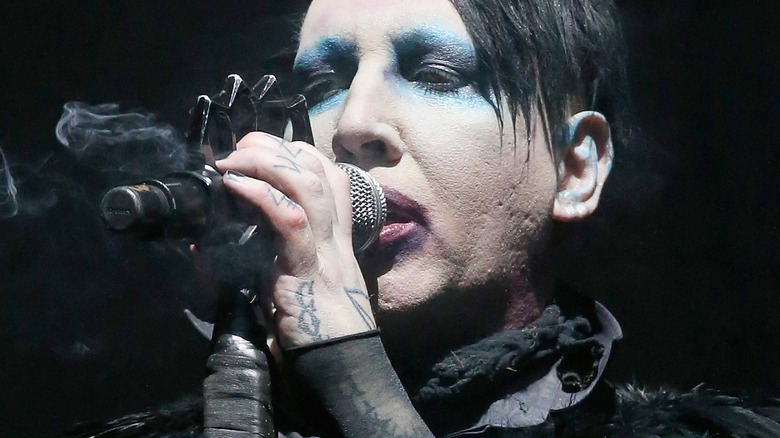 marilyn manson sings into microphone 