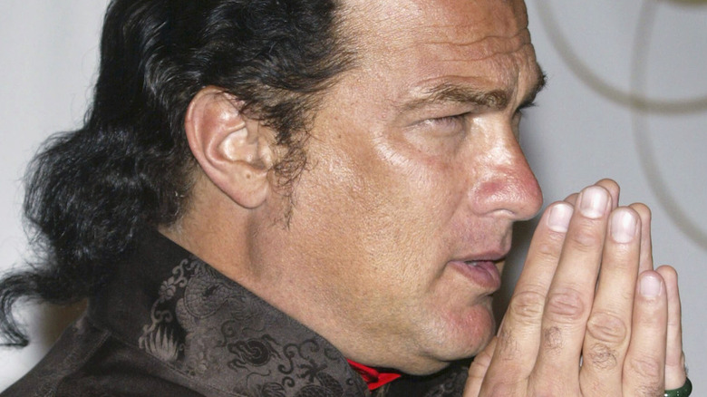 Seagal wincing with palms