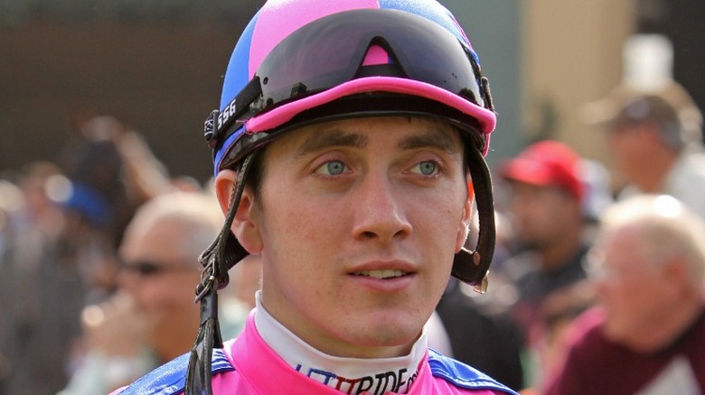 A close-up of Michael Baze facing forward wearing a jockey helmet