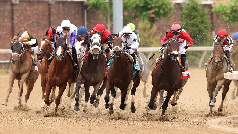 Horses gallop around the bend during the 2022 Kentucky Derby