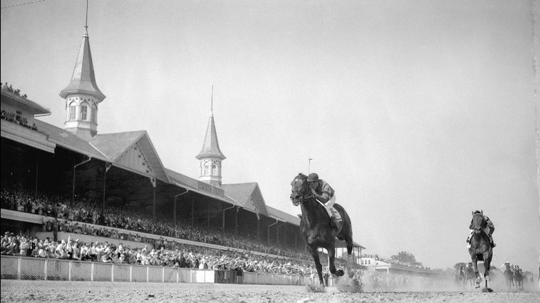 Black and white photo of horses racing