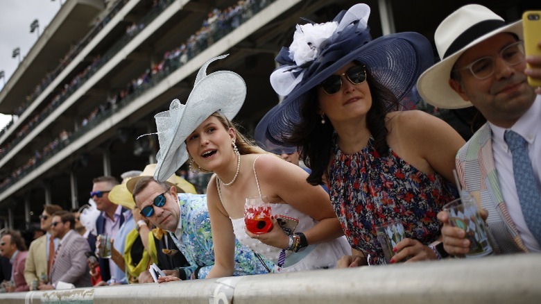 A crowd cheering in the stands at the 2022 Kentucky Derby