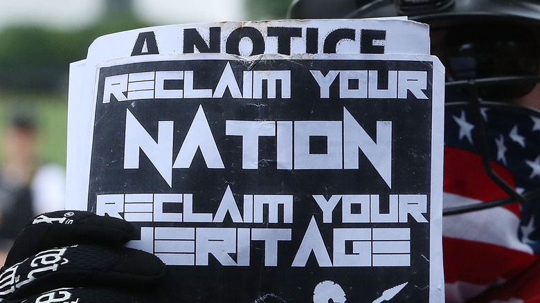 Reclaim Your Nation sign held protest