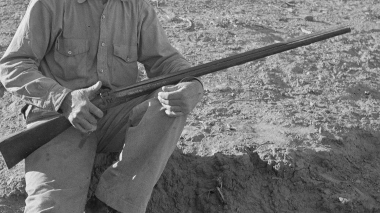 Southern farmer holding a gun
